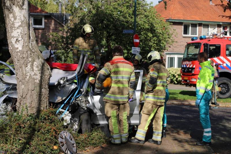 Automobiliste crasht tegen boom, brandweer knipt dak eraf