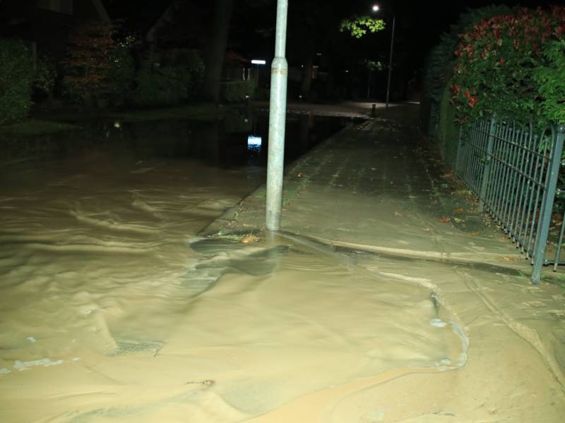 Straat blank door gesprongen waterleiding