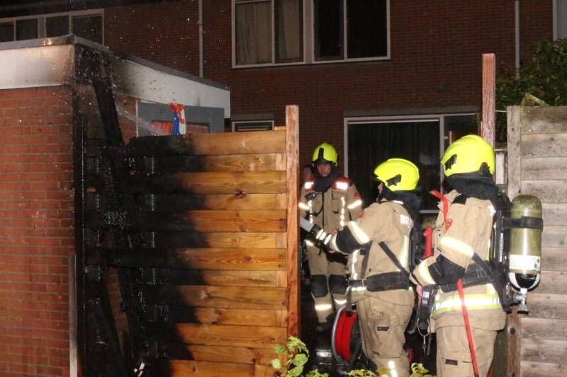 Auto met vloeistof besmeurd, schutting in brand gestoken