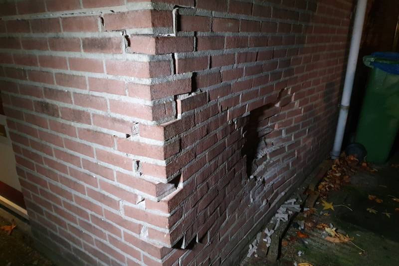 Geparkeerde auto ramt gevel na aanrijding