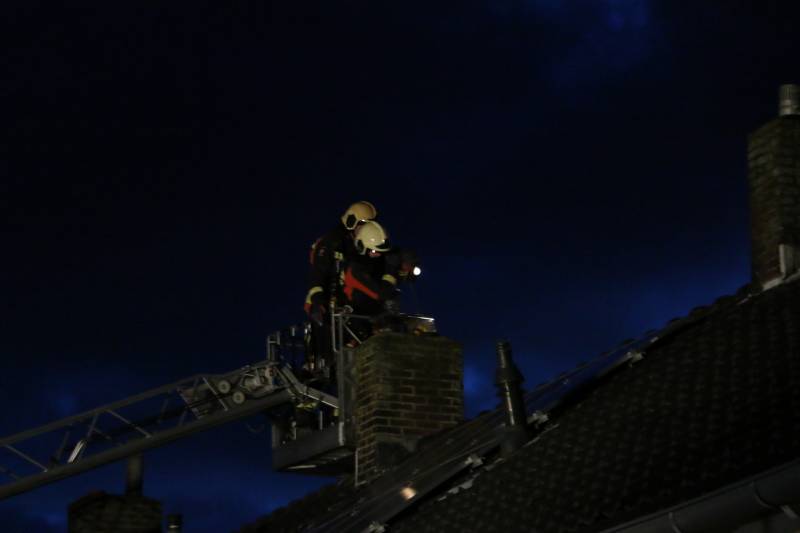 Brandweer veegt schoorsteen na brand