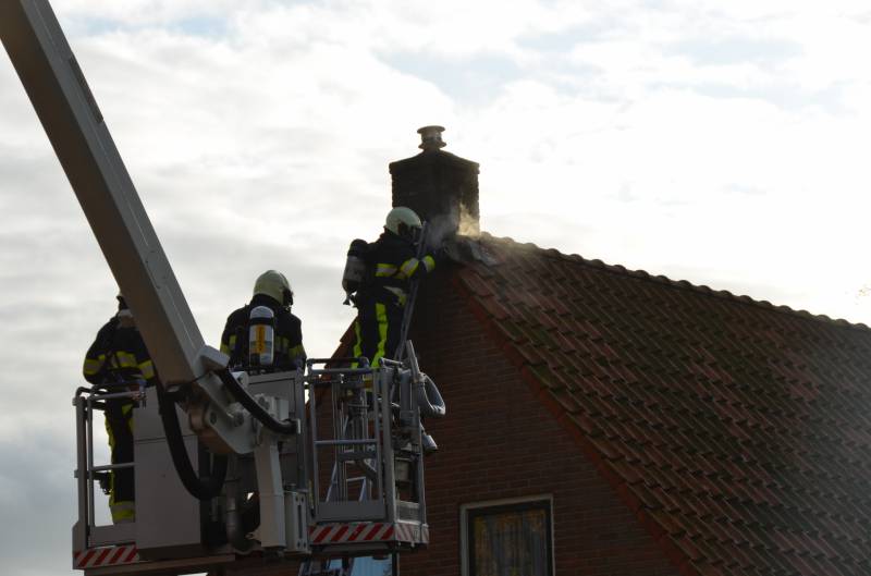 Brand in schoorsteen slaat door na dak