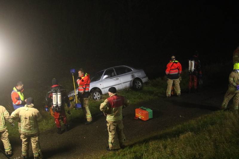 Auto raakt van dijk, brandweer doorzoekt sloot