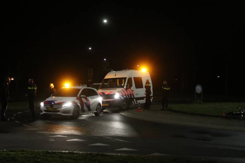 Fietser geschept door auto op rotonde