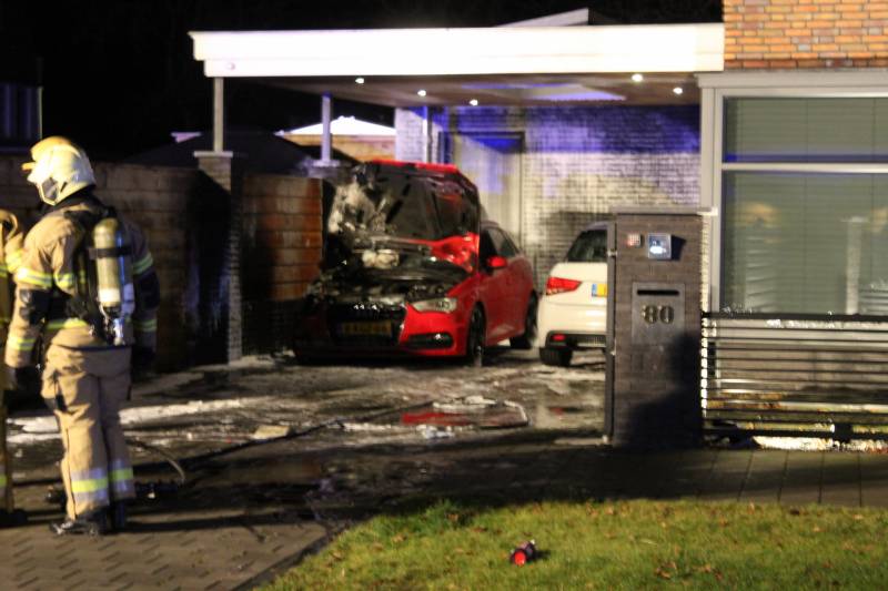 Auto in de brand onder carport