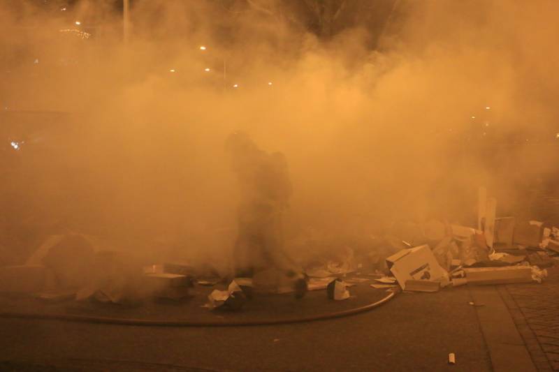 Brandweer druk met brand in container vol karton