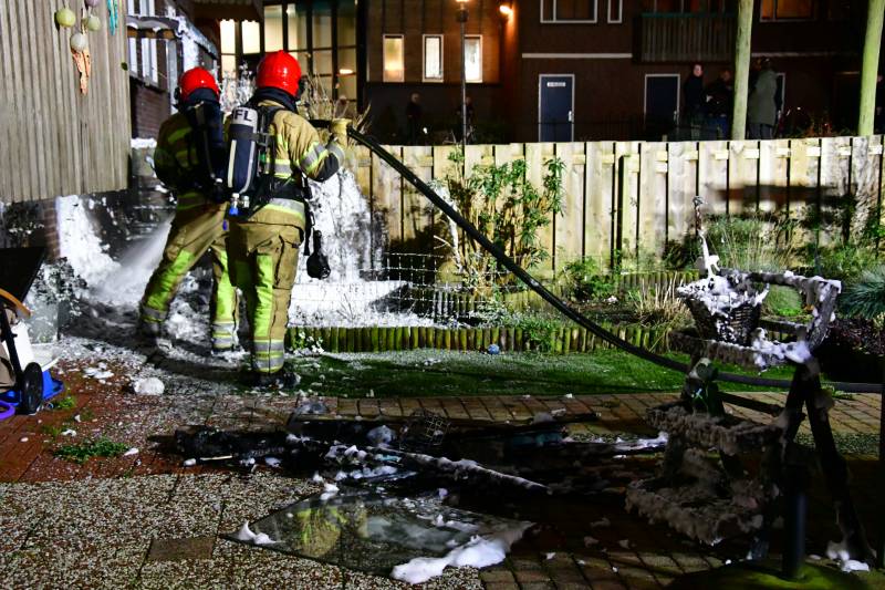 Brandweer blust brand onder balkon