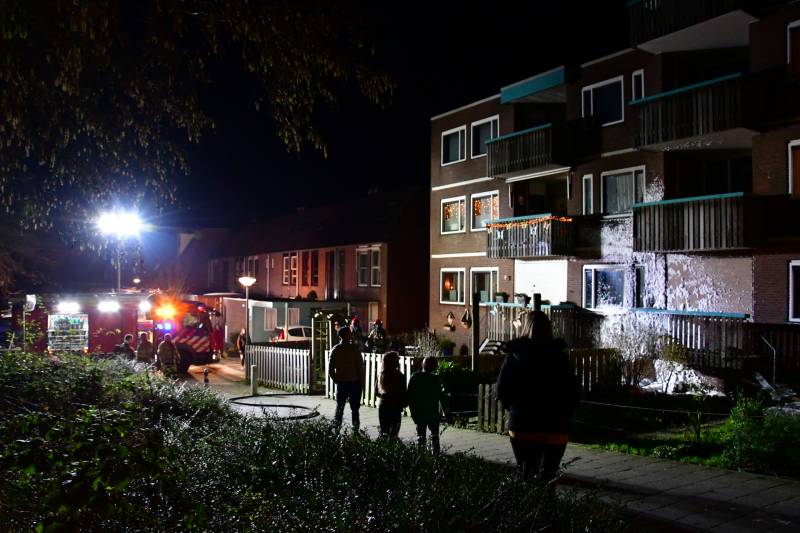 Brandweer blust brand onder balkon