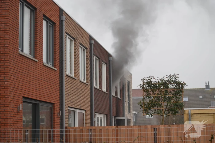 Dikke rookpluimen bij brand in woning