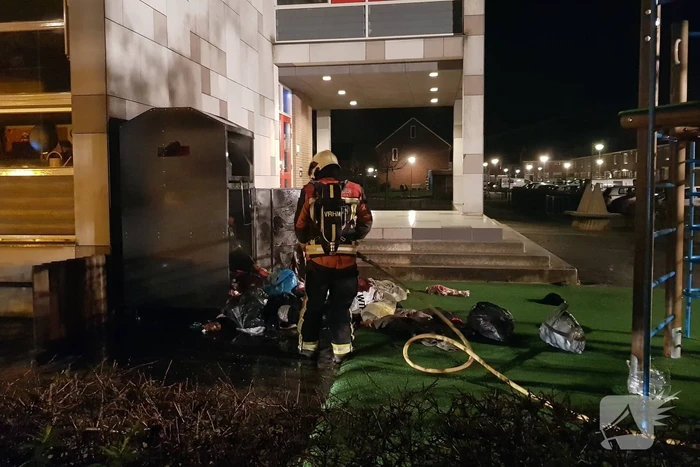 Kleding container vat vlam tegen schoolgebouw