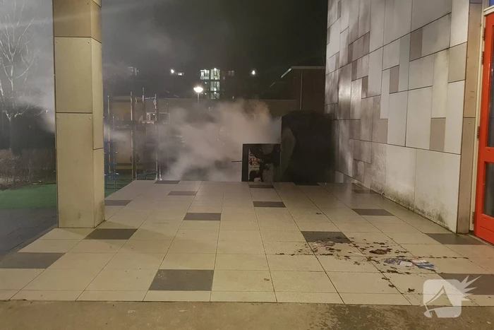 Kleding container vat vlam tegen schoolgebouw