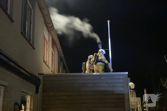 Brand in schoorsteenpijp van palletkachel achter woning