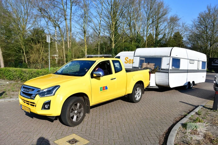 Handhaving sleept caravan met protesttekst weg van parkeerterrein gemeentewerf