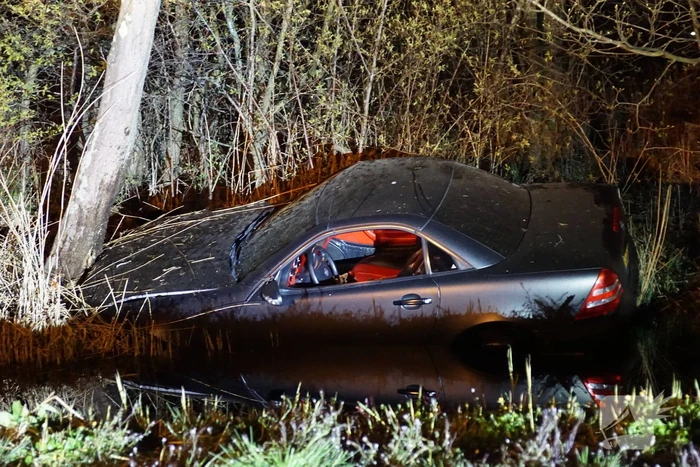 Auto te water, inzittende gewond