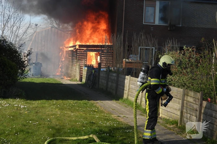 Uitslaande brand in schuur tegen woning aan