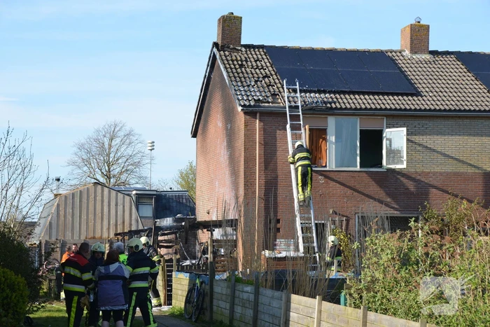 Uitslaande brand in schuur tegen woning aan