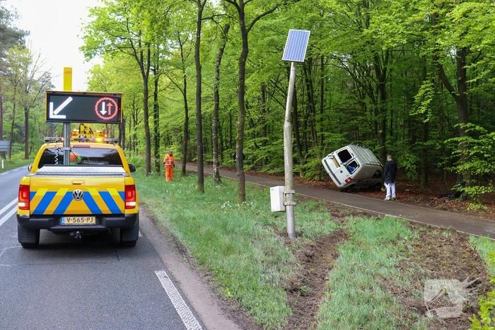Bestelbus belandt op zijn kant in bosschage
