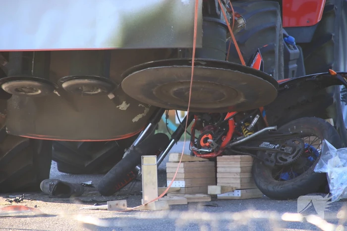 Scooter en scooterrijder bekneld onder tractor na ongeval