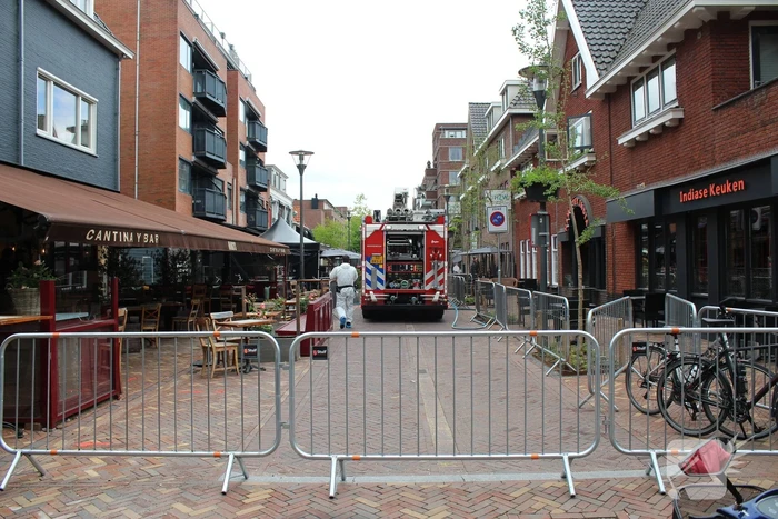 Woningbrand in winkelstraat