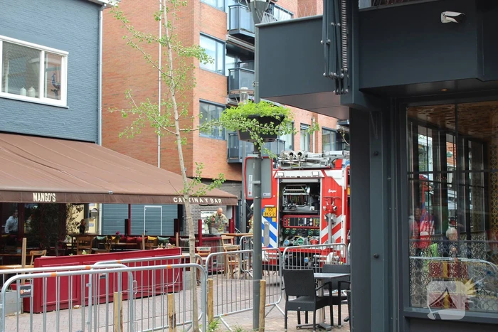 Woningbrand in winkelstraat