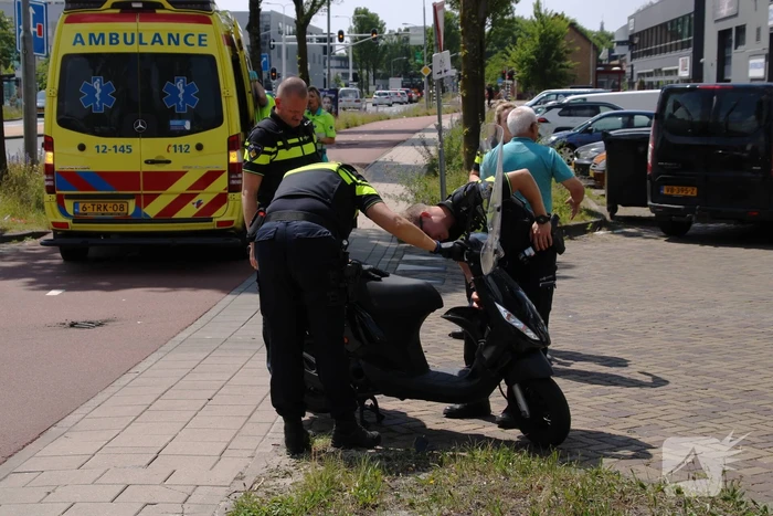 Scooterrijder botst op afslaande bestelbus