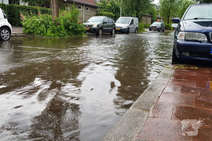 Straat onder water na wolkbreuk