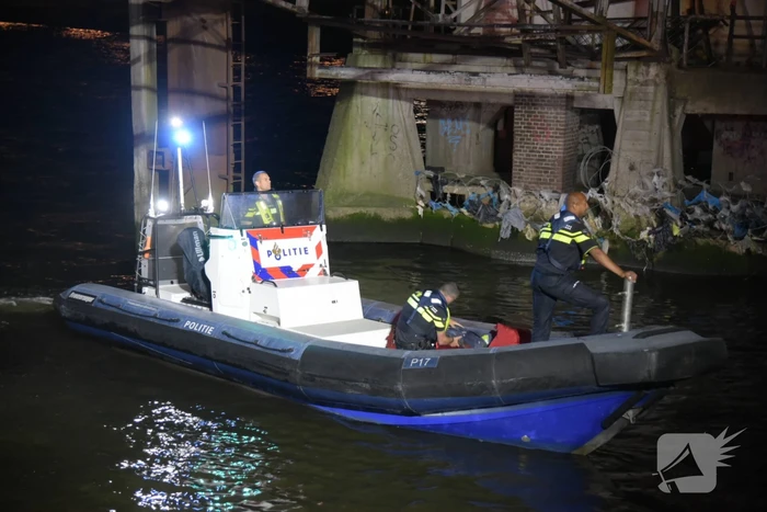 Omstanders halen persoon uit te water geraakte auto