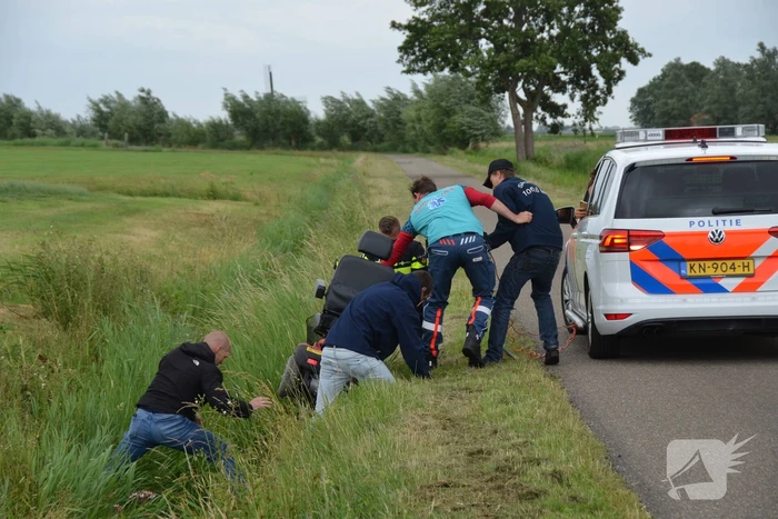 Omstanders halen scootmobiel uit greppel