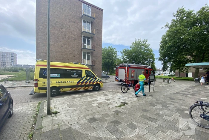 Kind raakt bekneld onder deur flatwoning