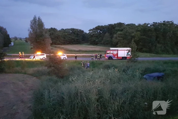 Bestelbus vliegt over de vangrail belandt in riet