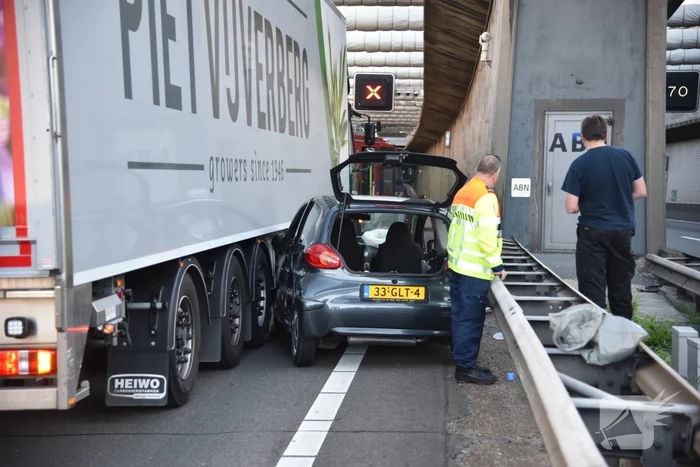 Auto klem tussen vangrail en vrachtwagen in Beneluxtunnel