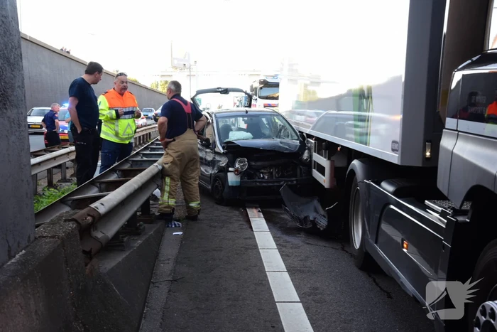 Auto klem tussen vangrail en vrachtwagen in Beneluxtunnel