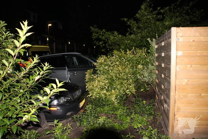 Auto botst op twee geparkeerde auto's en belandt in achtertuin