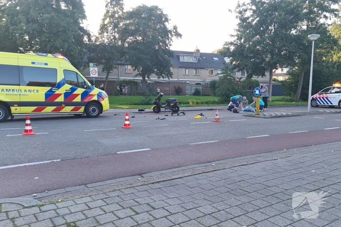 Taxi en scooter botsen op kruising