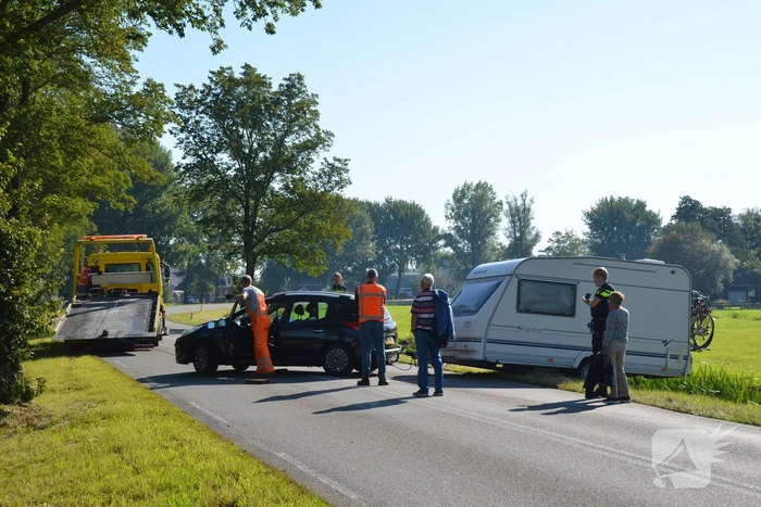 Auto met caravan raakt van de weg