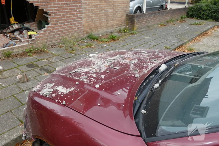 Automobilist rijdt garage in bij wegrijden