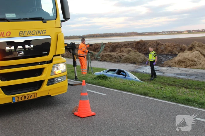 Personenauto raakt steen en rijdt het water in