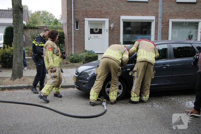 Brandweer blust brand in motorkap
