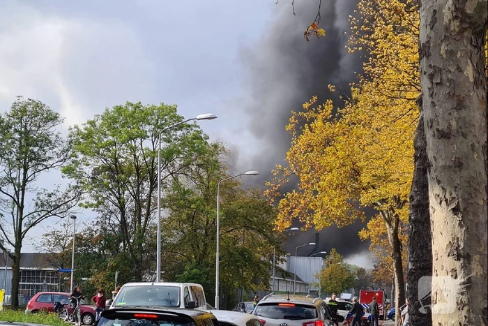 Dikke rookwolken boven industrieterrein bij brand in pand Sims Lifecycle Services