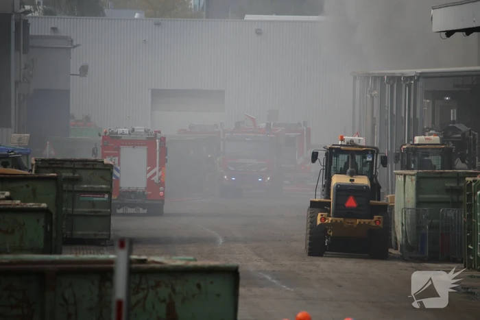 Dikke rookwolken boven industrieterrein bij brand in pand Sims Lifecycle Services