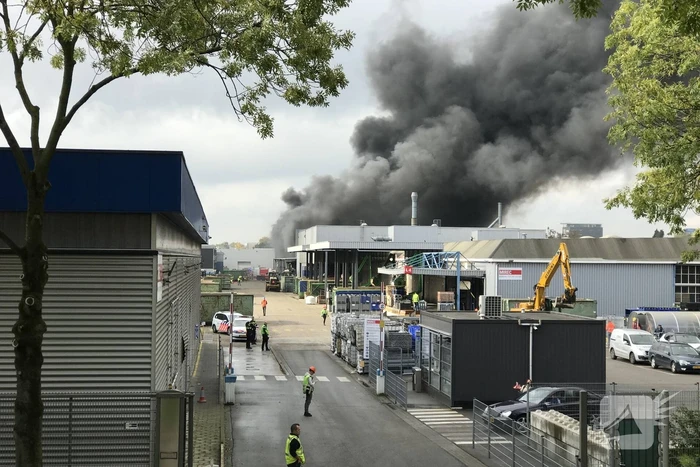 Dikke rookwolken boven industrieterrein bij brand in pand Sims Lifecycle Services