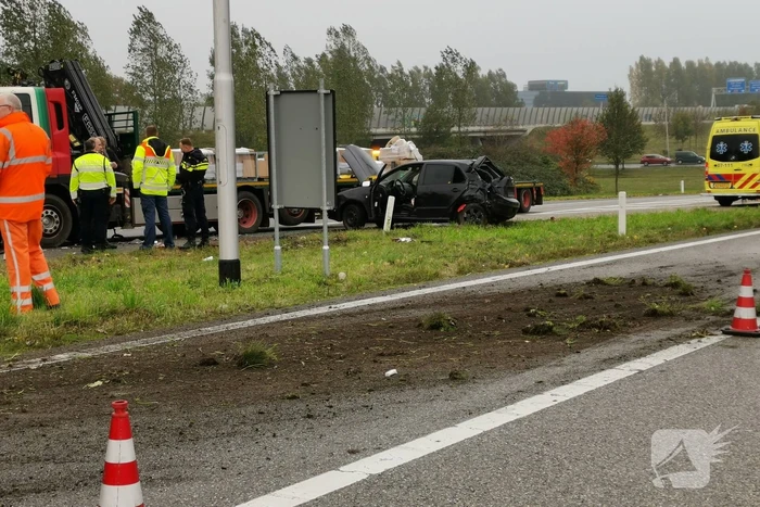 Auto van afrit geschoten, botst frontaal op vrachtwagen