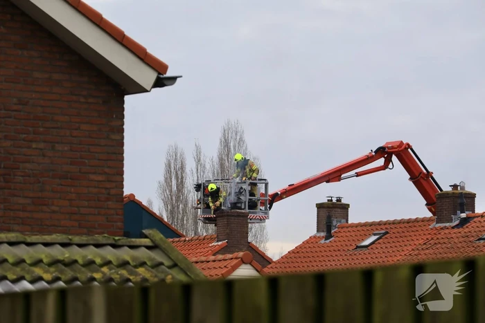 Brandweer blust brand in schoorsteen
