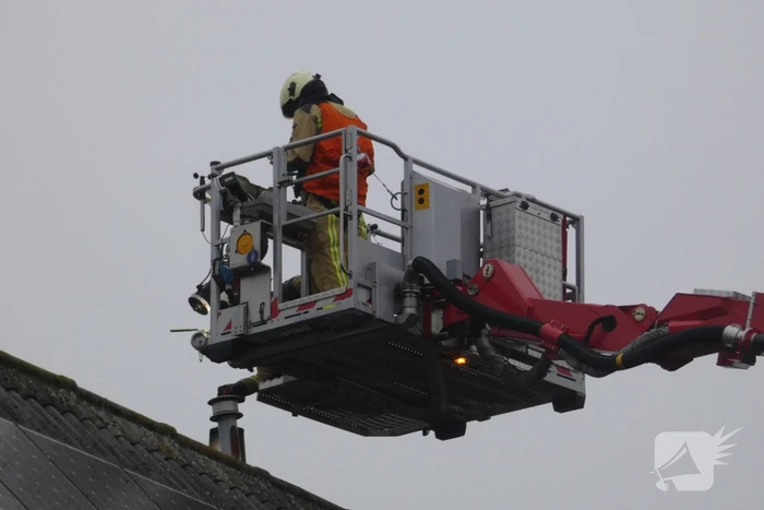 Brandweer blust brand in schoorsteen
