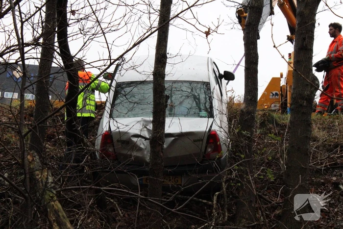 Auto glijdt greppel in bij afrit snelweg
