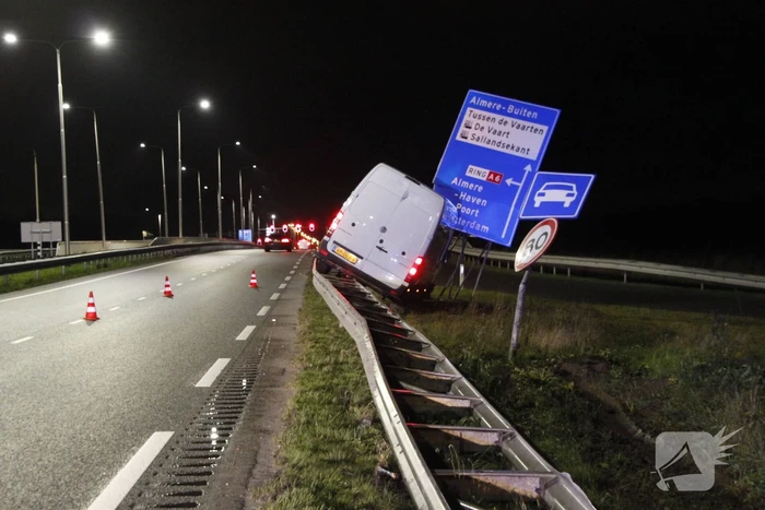 Bestelbus rijdt op vangrail en raakt verkeersborden