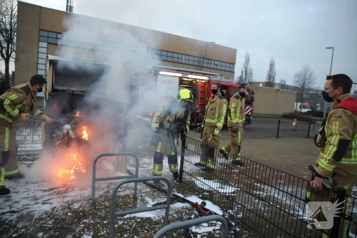 Flinke vlammen bij brand in kledingcontainer