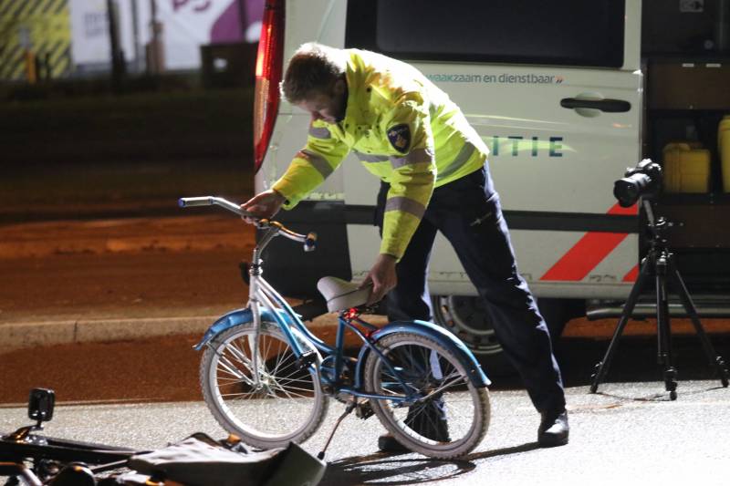 Fietsers aangereden door politieauto