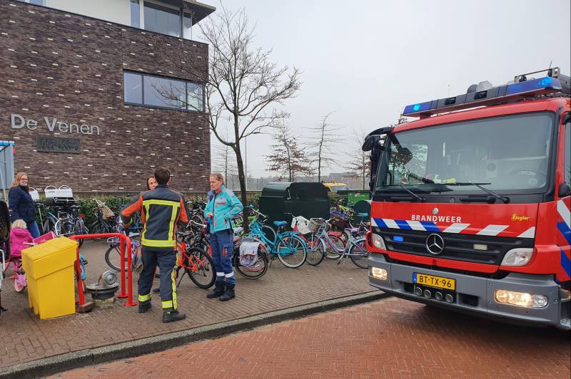 Meisje met voet klem tussen spaken van fiets