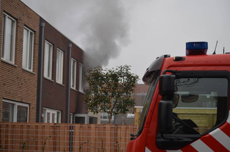 Dikke rookpluimen bij brand in woning
